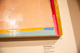 Textured peach, yellow, and blue abstract art detail with gold-edged wood panel.