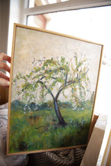 Textured brushstrokes of white and pink blossoms on Grace B. Keogh's painting with wooden frame.