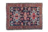 Vintage Karaja square rug with a double medallion design in blush, red, and powder blue on a navy field.