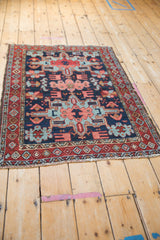 Perspective view of a vintage Karaja collector rug showing its geometric medallion and border design.
