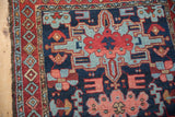 The tattered side and diamond pearl main border of a vintage collector Karaja rug.