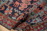 Hand-knotted texture of a vintage Karaja rug with navy, red, and blue geometric florals.