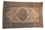 Distressed Malayer rug with a navy Herati medallion, ivory paisley field, and blue and red floral borders.