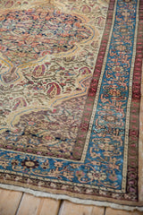 Corner detail of a distressed Malayer rug highlighting the sky blue border and low, even pile.