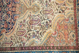 Worn, hand-knotted pile of a vintage Malayer showing paisley boteh motifs and colorful floral borders.