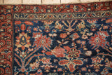 Vintage Hamadan rug corner, navy field with blossom vinery and palmettes, rust border.