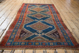 Kurdish Hamadan rug corner, madder red and indigo borders with star motifs, tattered edges.