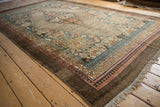 Distressed Persian Bibikabad rug corner, faded blue and red borders, deep chocolate brown selvage.