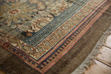 Distressed Bibikabad rug border detail: worn pile, denim blue, madder red, and sand motifs.