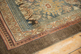 Distressed Bibikabad rug corner, with madder red, denim blue borders and soft pile wear.