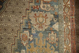 Distressed geometric lattice and stepped border with dusty teal and gold palmettes.