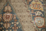 Distressed Bibikabad carpet detail: diamond lattice, dusty teal field, and stylized animal palmette patterns.
