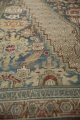 Distressed Bibikabad rug section with dusty teal, sand, chestnut palmettes and lattice patterns.