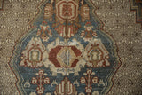 Distressed Bibikabad rug detail: dusty teal spandrel, lattice field, and artistic palmette motifs.