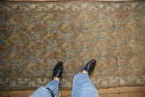 Distressed vintage Bibikabad runner pile with coffee brown floral and sky blue vine border.