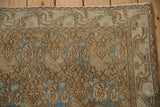 Faded floral motifs in pale coffee brown and sky blue, distressed with visible foundation.
