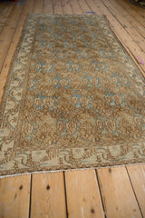 Distressed Bibikabad runner showing pale coffee and sky blue floral field, vine border.
