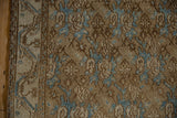 Distressed Bibikabad runner, worn pale brown field, sky blue floral motifs, and vine border detail.