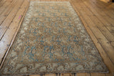 Distressed Bibikabad runner corner: worn floral vine border in pale coffee brown and sky blue.