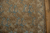 Distressed pale brown and sky blue floral vine motifs on a vintage Bibikabad rug border.