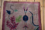 Pictorial cobalt blue lantern motif on vintage Art Deco rug with dusty mauve border and tattered fringe.