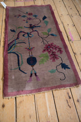 Nichols Art Deco rug detail: Tattered mauve edge and dark blue pictorial lantern.