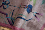 Textured pile of a Vintage Nichols Art Deco rug with cobalt blue lantern motif.