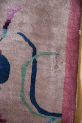 Dusty mauve pile with cobalt blue and aqua green scrolling Art Deco branches and mauve border.