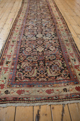 Vintage Persian Mahal runner's Herati design and worn texture seen from a long, angled perspective.