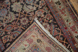 A folded corner on a vintage Mahal runner reveals visible knot heads and the hand-knotted woven foundation.