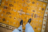 Saffron yellow vintage Moroccan rug featuring geometric floral guls, blossoms, and ivory border.