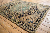 Distressed vintage Malayer rug showing faint foundation, navy and ivory tones.