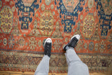Antique Caucasian Soumac rug with brick red, sapphire blue geometric gul medallions, zig-zag blossom border.