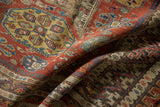 Antique Soumac carpet detail: dark field with complex geometric and angular patterns.