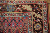 Antique Kurdish rug corner: cherry red geometric field and artistic serrated leaf palmette border.