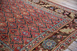 Antique Kurdish rug runner, cherry red geometric trellis field, dark chocolate serrated leaf palmette border.