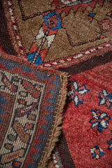 Antique Azeri runner detail: hand-knotted pile, knot heads, serrated diamond, pinwheel motifs. Camel, red, blue.