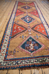 Antique Azeri runner's geometric borders in sapphire blue and madder red, showing varied pile.
