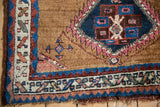 Antique Azeri rug corner, camel field with serrated sapphire medallion and geometric borders.