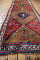Textured hand-knotted pile of the antique Azeri runner, displaying camel, madder red, and deep teal motifs.
