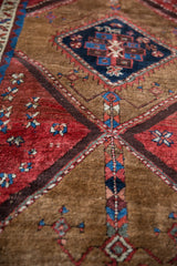 Antique Azeri rug: deep teal diamond medallion, serrated red outline, camel and madder root red fields.