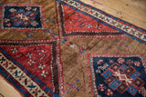 Antique Azeri rug detail shows sapphire diamond medallion, madder red serrated border, pile wear.
