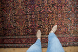 Antique Northwest Persian rug with Herati design, scattered animal motifs, and patterned border.