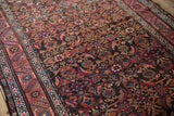 Antique Northwest Persian rug's Herati pattern and border, displaying red, blue, and brown pile.
