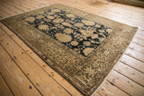 Vintage Malayer rug corner with intricate floral border in beige, olive, and coffee brown.