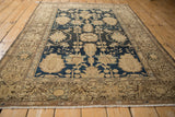 Vintage Malayer rug detail showing beige floral border, navy blue field, and germinating blossoms.