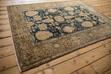 Vintage Malayer rug showing secured side selvage and intricate floral vine outer border.