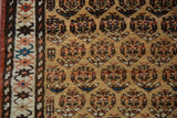 Fine detail of antique Northwest Persian runner showcasing gold field, repeating boteh, and multicolor border.