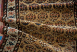 Folded antique Northwest Persian runner, gold ground, rainbow boteh motifs, and geometric border.