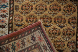 Folded corner of antique Northwest Persian runner, revealing hand-knotted back and colorful boteh pile.